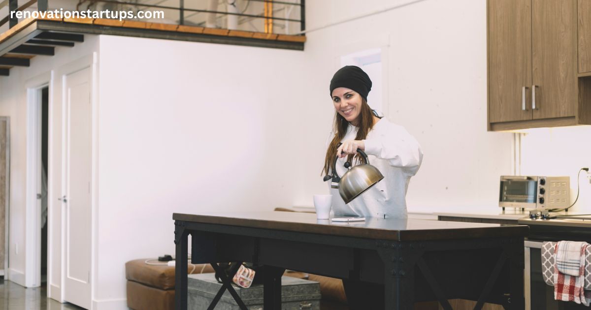 Woman pouring tea in renovated open-concept kitchen with wood cabinets — kitchen renovation cost Toronto