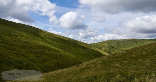 Green grassy hills and a valley under a blue sky with puffy white clouds, labeled Long's HillGreen grassy hills and a valley under a blue sky with puffy white clouds, labeled Long's HillGreen grassy hills and a valley under a blue sky with puffy white clouds, labeled Long's HillGreen grassy hills and a valley under a blue sky with puffy white clouds, labeled Long's HillGreen grassy hills and a valley under a blue sky with puffy white clouds, labeled Long's HillGreen grassy hills and a valley under a blue sky with puffy white clouds, labeled Long's HillGreen grassy hills and a valley under a blue sky with puffy white clouds, labeled Long's Hill.