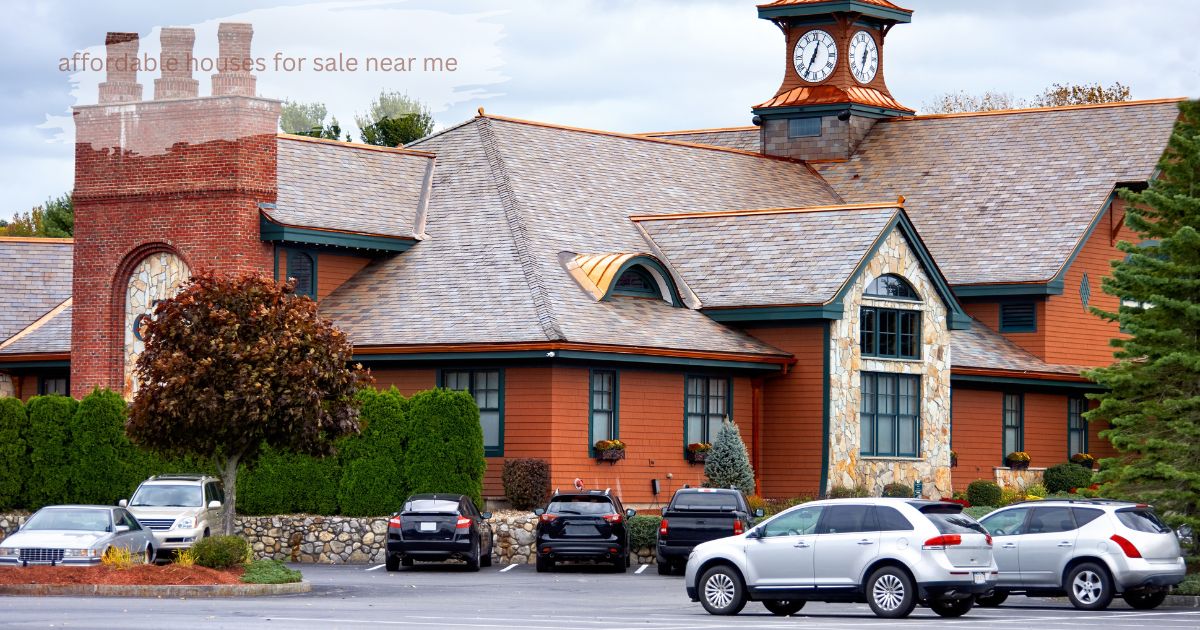 Brick building with decorative chimneys and parked cars in an asphalt parking area.’Affordable Houses for Sale Near Me’