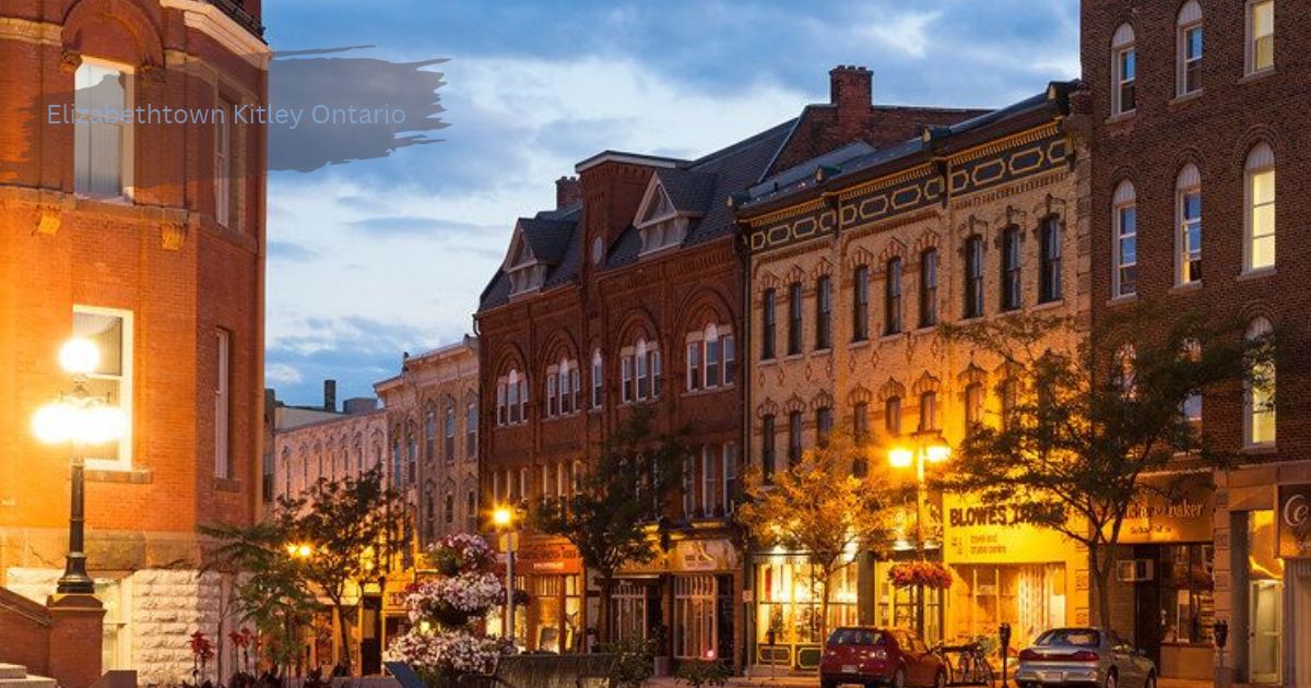 Historic brick buildings and glowing street lamps lining a downtown street at dusk in Elizabethtown Kitley Ontario.