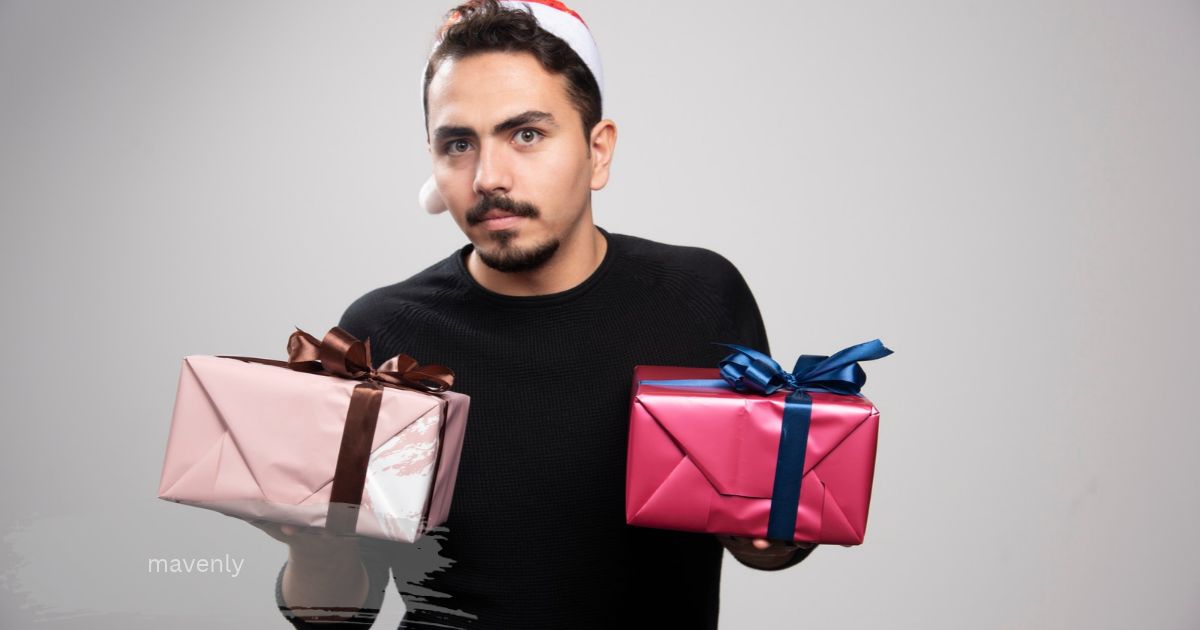 man in a Santa hat holding two wrapped gift boxes while choosing a mavenly present