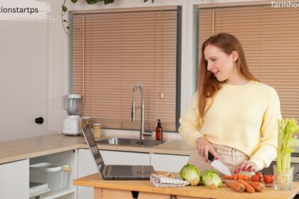 Woman prepping vegetables in a modern white kitchen featuring a stainless steel farmhouse sink and wooden countertops