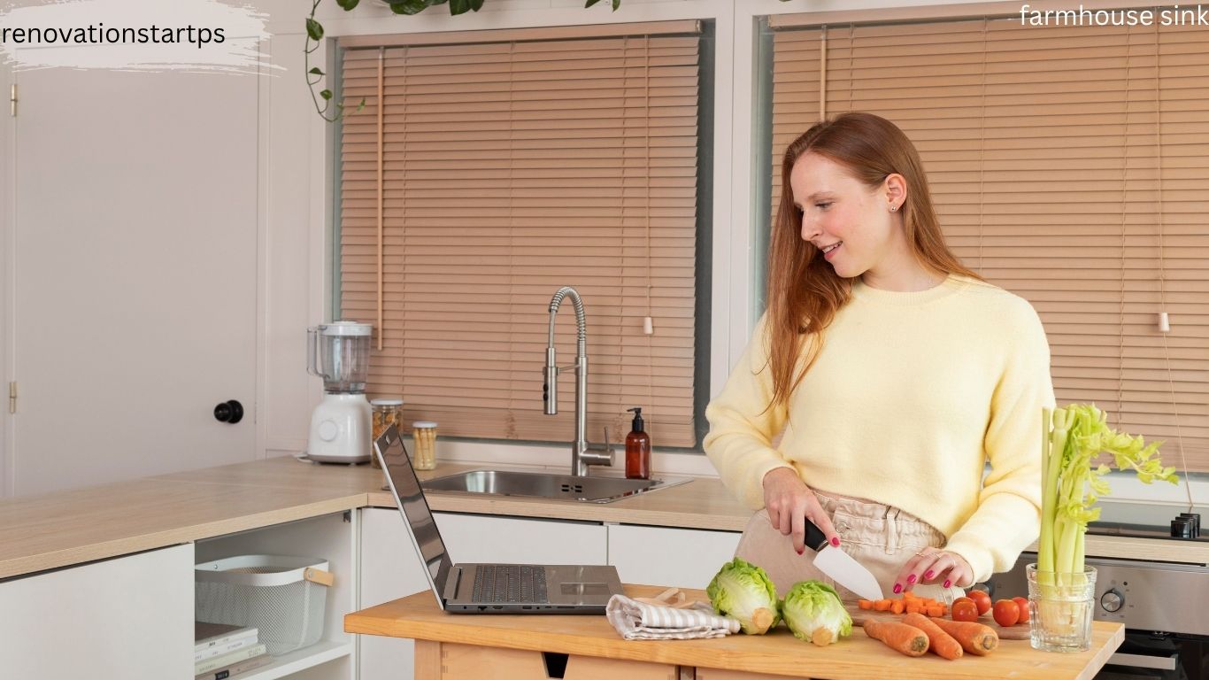 Woman prepping vegetables in a modern white kitchen featuring a stainless steel farmhouse sink and wooden countertops