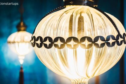 Close up of vintage globe light bulbs with decorative black metal trim glowing with warm yellow light