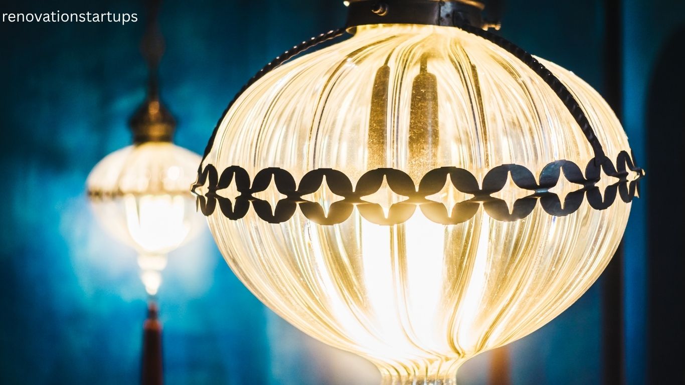 Close up of vintage globe light bulbs with decorative black metal trim glowing with warm yellow light