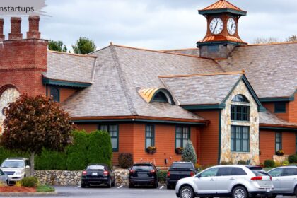 A beautiful Regina estate home with a multi-tiered slate roof, copper accents, and a distinctive clock tower, showcasing premium listings available on the MLS Regina market.