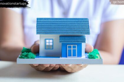 Hands holding a blue miniature house model representing QE Home Canada's trusted family-owned brand
