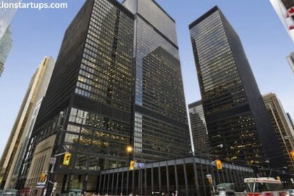 TD Bank Tower at 66 Wellington Street West in Toronto's Financial District, showing the dark glass-and-steel Toronto-Dominion Centre towers at dusk with street traffic below