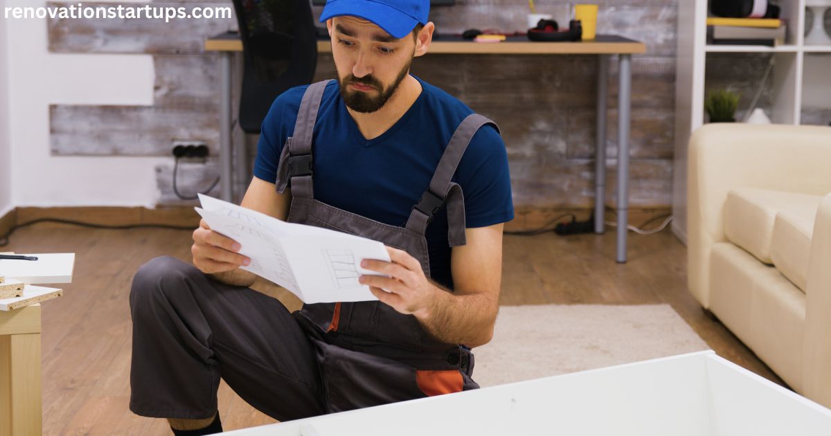 Contractor in overalls reviewing blueprint sketches to estimate basement renovation cost