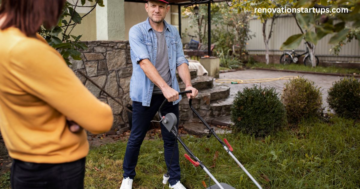 Man mowing backyard lawn with woman watching during backyard renovation