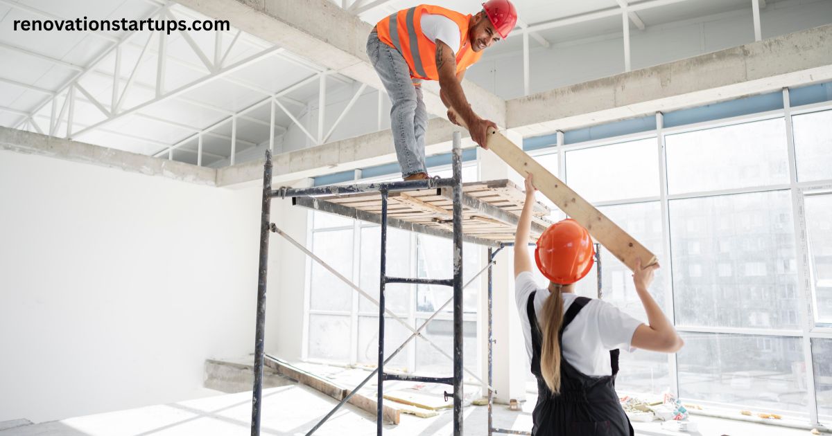 Commercial renovation contractors working on scaffolding in an office space with wood plank and hard hats.