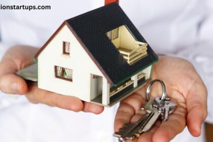 Person holding a small model house and keys, symbolizing houses and rent