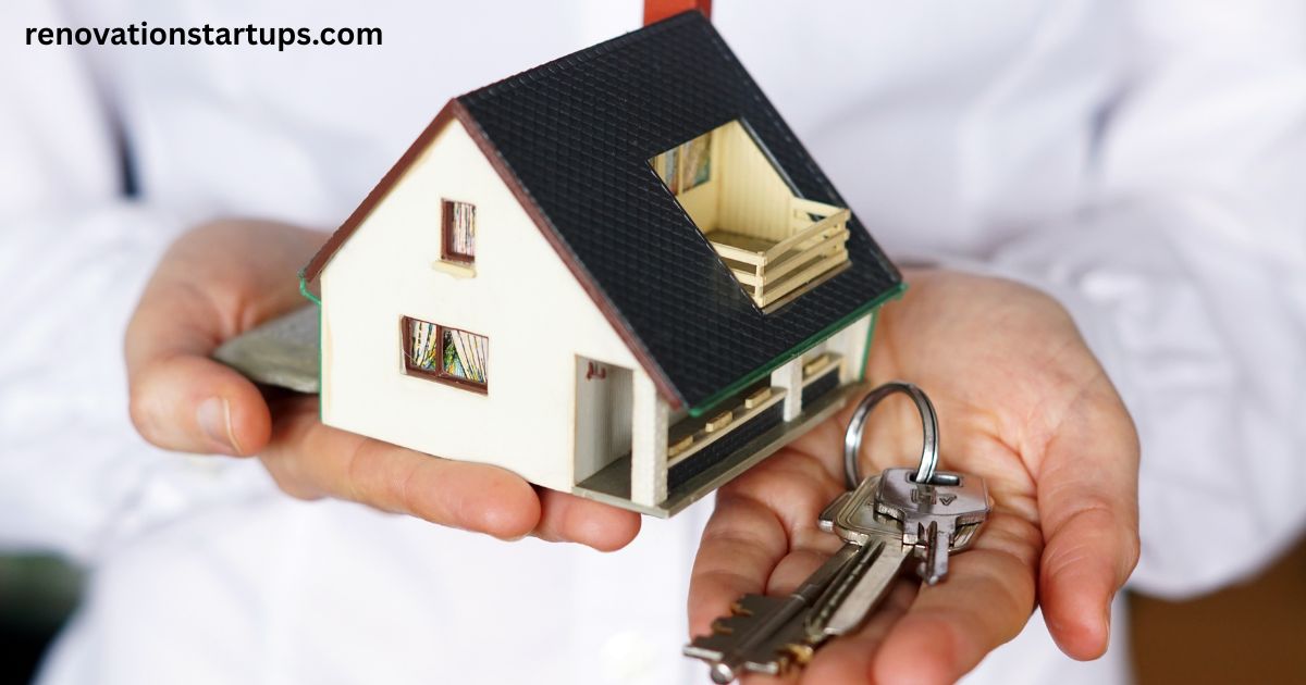Person holding a small model house and keys, symbolizing houses and rent