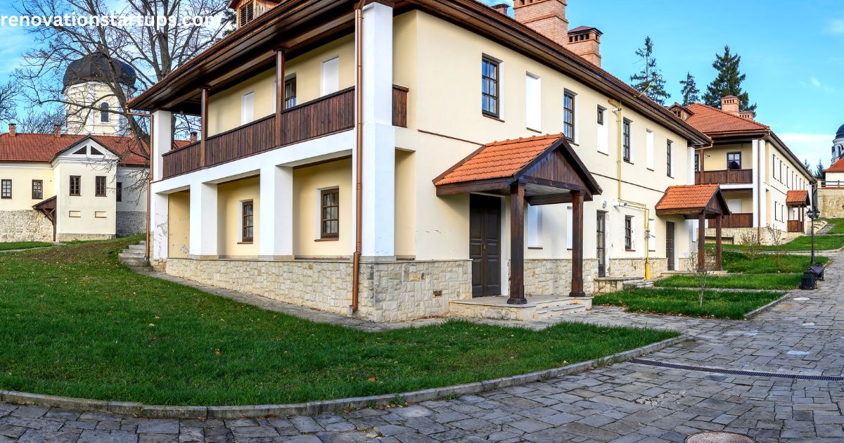Two-storey stone-and-stucco house with a wooden balcony and red-tiled roof, an example of homes similar to houses for sale in Winnipeg