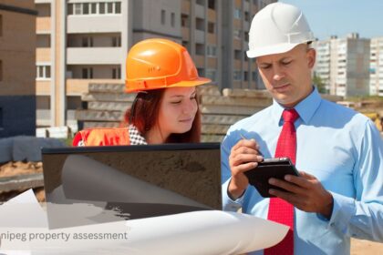 City of Winnipeg property assessment inspector reviewing building blueprints at a residential construction site