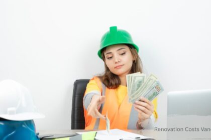 Female general contractor holding cash and using a calculator to plan budget and renovation costs vancouver