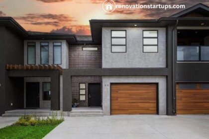 Modern Winnipeg condos for sale with dark exterior, wood garage doors, and sunset sky