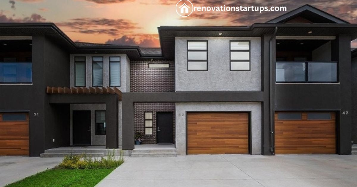 Modern Winnipeg condos for sale with dark exterior, wood garage doors, and sunset sky
