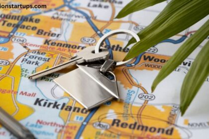 Silver house key with a house keychain lying over a local regional map, symbolizing home buying, real estate relocation, and property navigation.