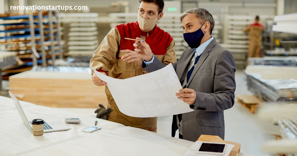 Contractor and homeowner reviewing blueprints together while discussing basement renovation financing options and project plans