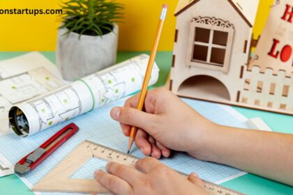 Miniature house model, stacked coins, keys, and a blueprint representing full house renovation cost planning and budgeting.