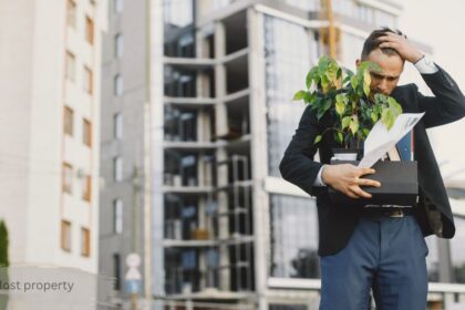 Stressed businessman carrying office box and plant, illustrating the frustration of dealing with SWR lost property