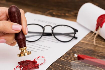 Hand stamping a wax seal on a property document, representing the Reeves stamp duty property tax for Canadian buyers