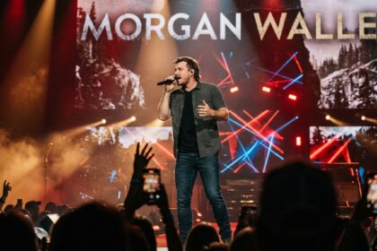 Morgan Wallen performs live on stage in Edmonton, captured in a high-energy concert photo with the crowd.