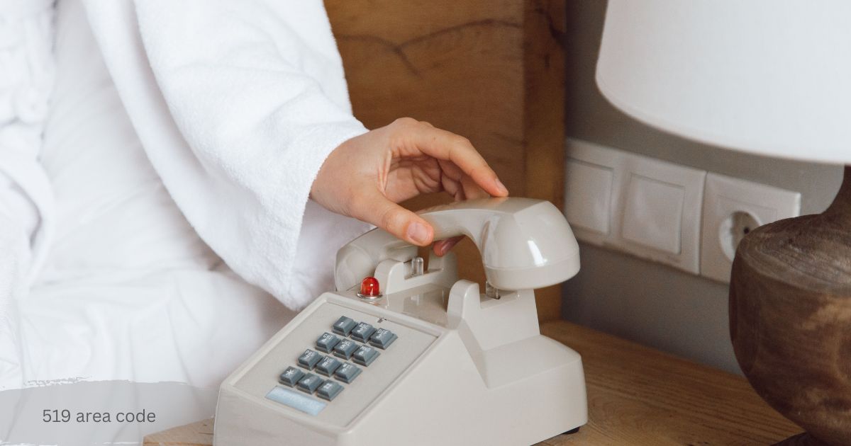 Hand placing the receiver on a cream push button phone beside a bed after a call from 519 area code