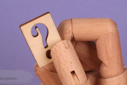 Wooden hand holding a question mark tag on a purple background to explain hazard pictograms