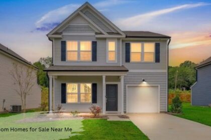 Two story gray home with black shutters, covered front porch, and attached one-car garage at sunset, a '3 bedroom home for sale near me'