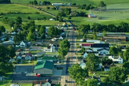 Aerial view of a small rural town with tree-lined streets, houses, and green farmland in Elizabethtown Kitley Ontario.