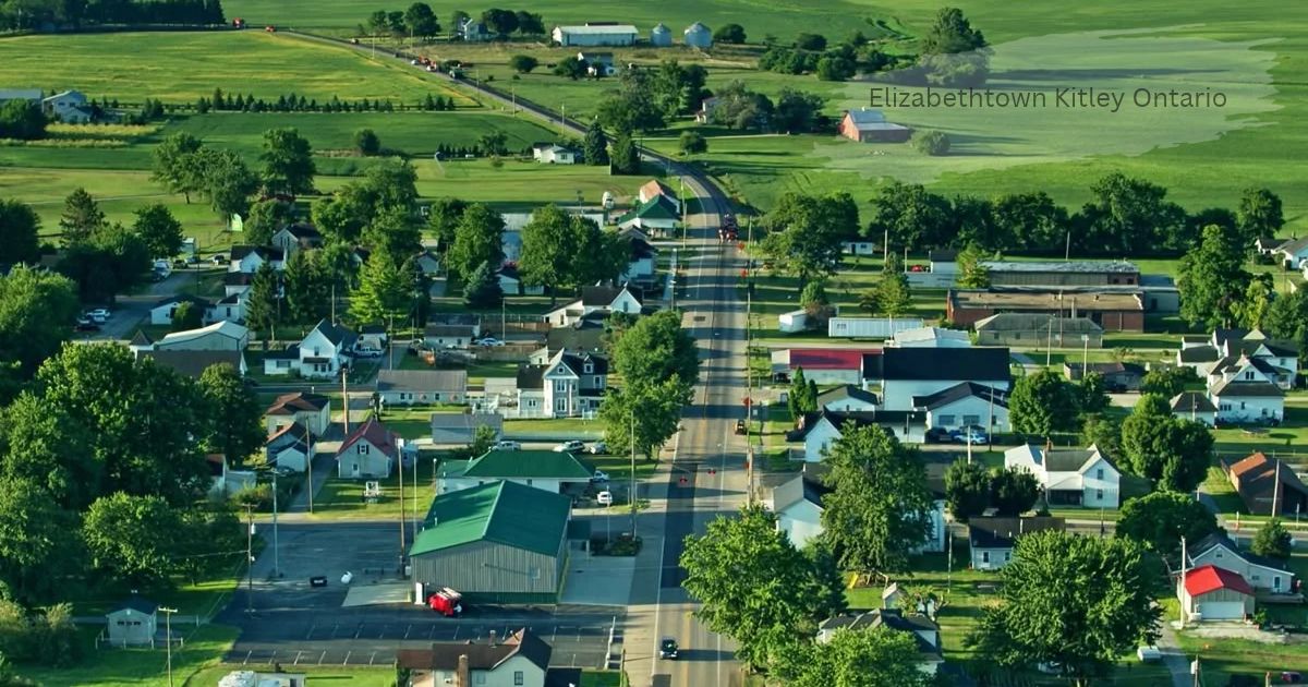 Aerial view of a small rural town with tree-lined streets, houses, and green farmland in Elizabethtown Kitley Ontario.