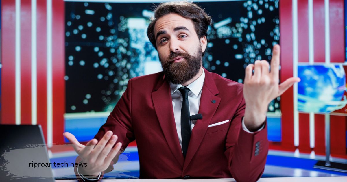 riproar tech updates presented by a bearded riproar tech news  anchor in a maroon suit speaking from a bright red and blue studio desk