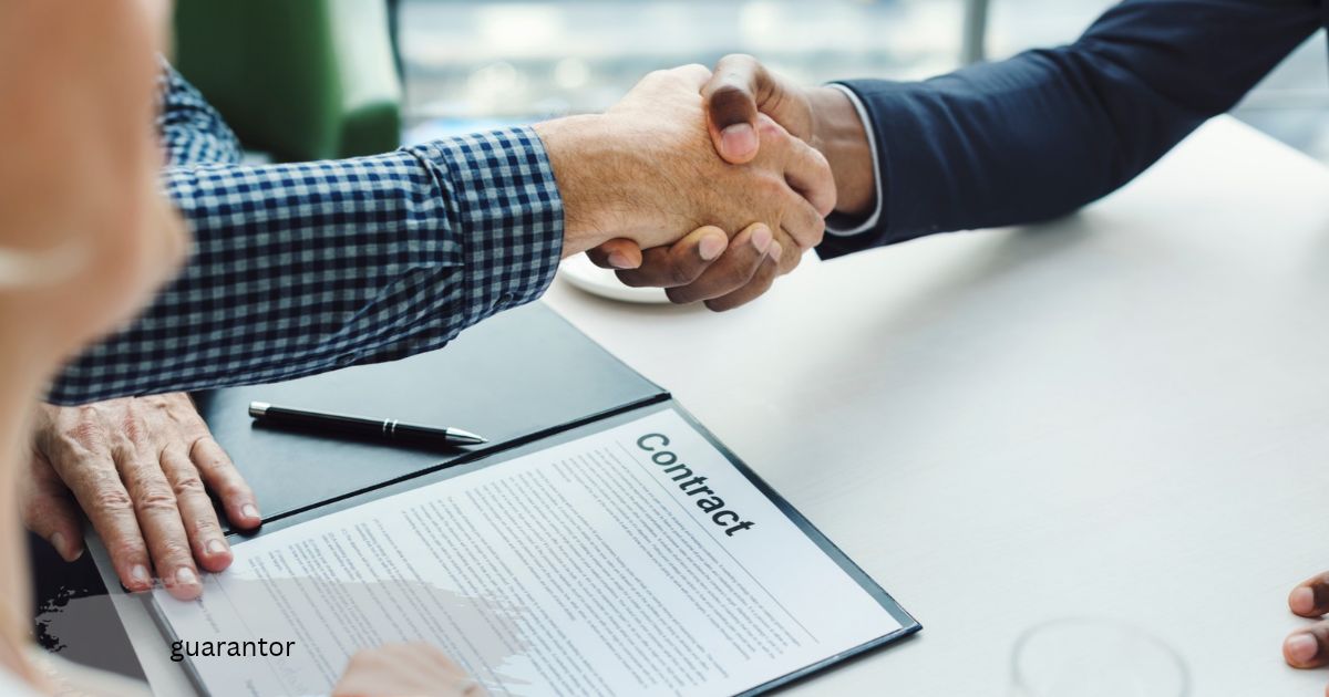 guarantor handshake over a signed contract on a table