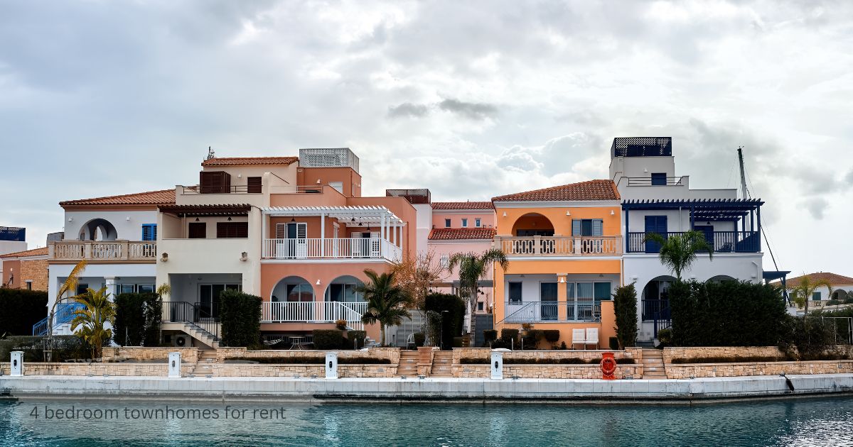 Colorful waterfront townhomes with balconies and palm trees, representing 4 bedroom townhomes for rent near a marina.