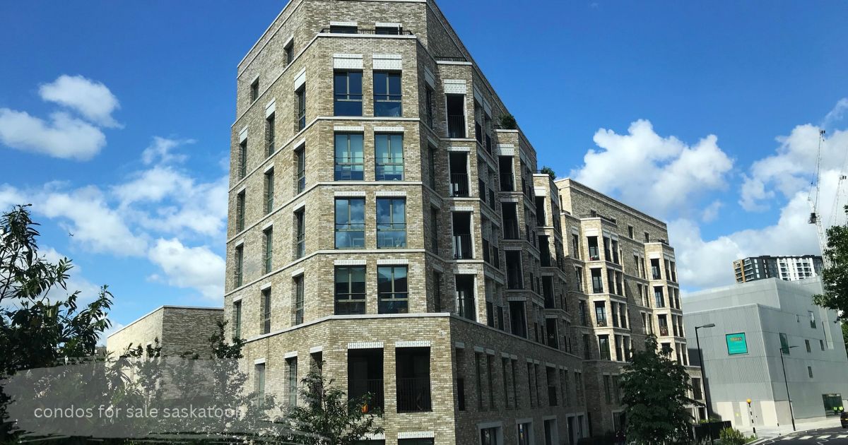 Modern multi-story residential condo building with light-colored brick exterior and large windows under a blue cloudy sky, with "condos for sale saskatoon" text overlay at the bottom.